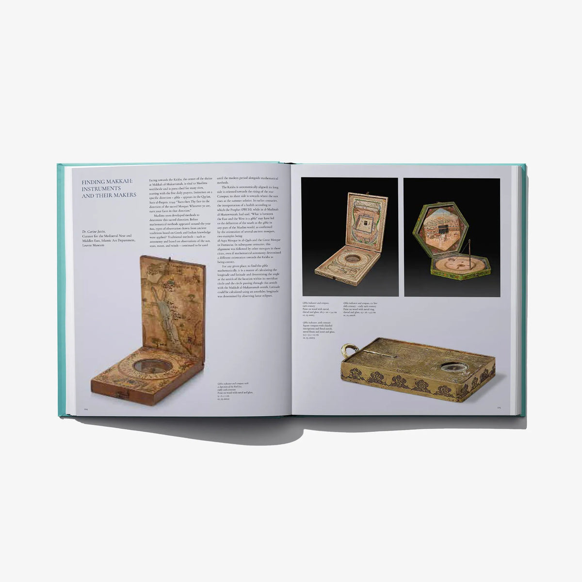 Open museum book spread with photos of small artifacts on white pages