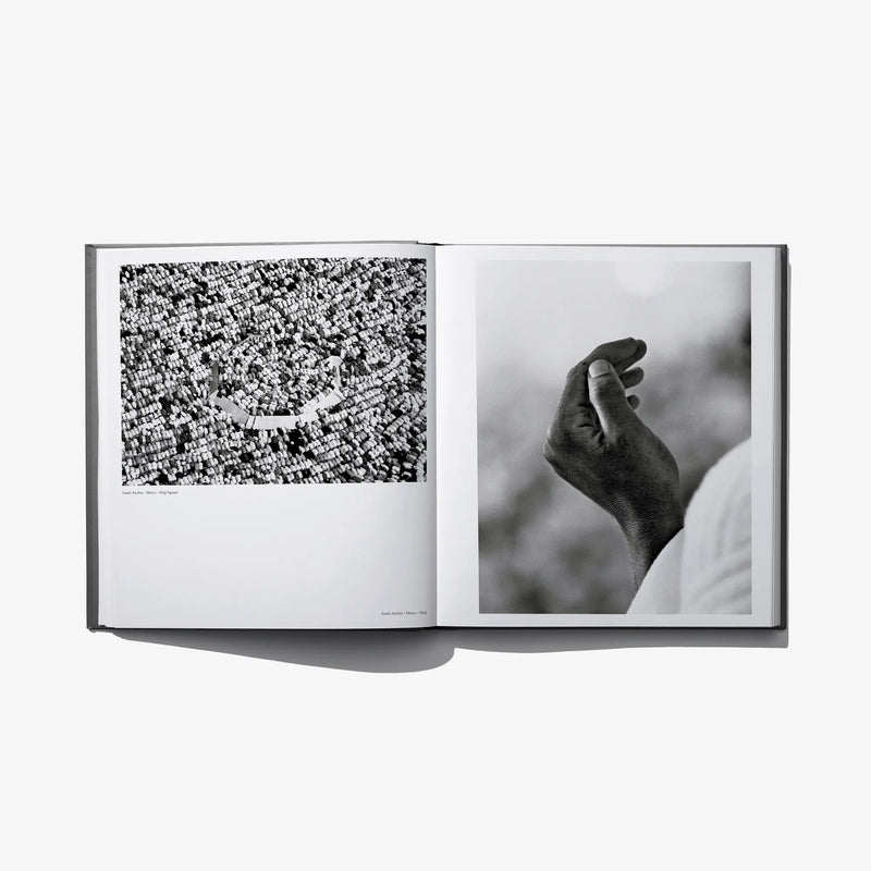 Open photo book spread with a patterned crowd image and a hand close-up, black-and-white