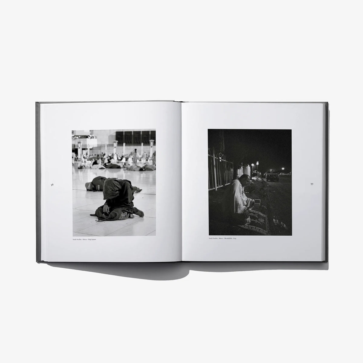 Open photo book spread with people in indoor night scenes, black-and-white photographs