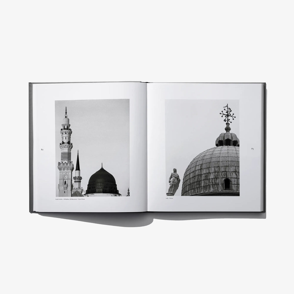 Open photo book spread showing mosque towers and a large dome, black-and-white photos