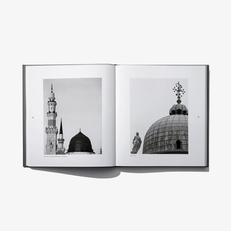 Open photo book spread showing mosque towers and a large dome, black-and-white photos
