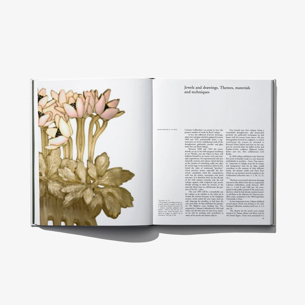 Open art book displaying a botanical flower illustration and a page of text