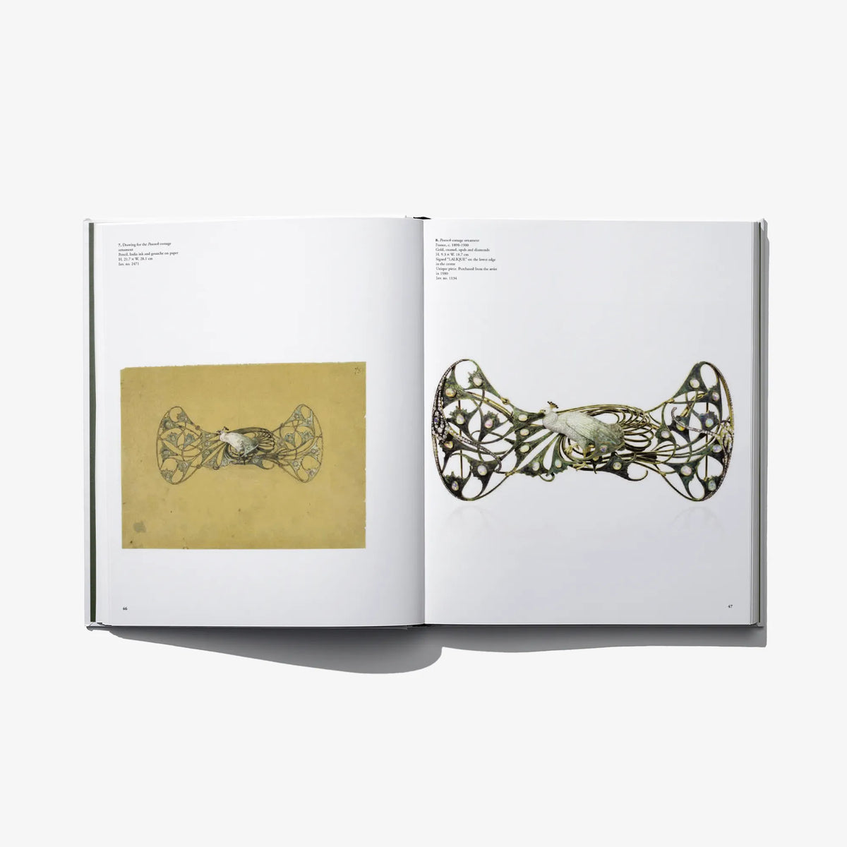 Open art book featuring gold-and-green ornamental jewelry drawings on two pages