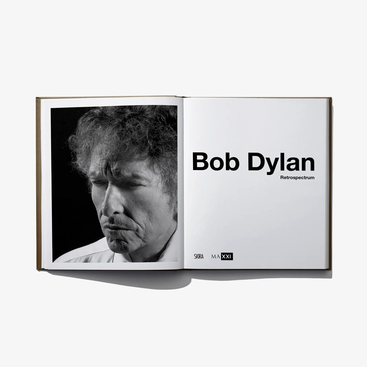Open book with black-and-white portrait photo and title text on right