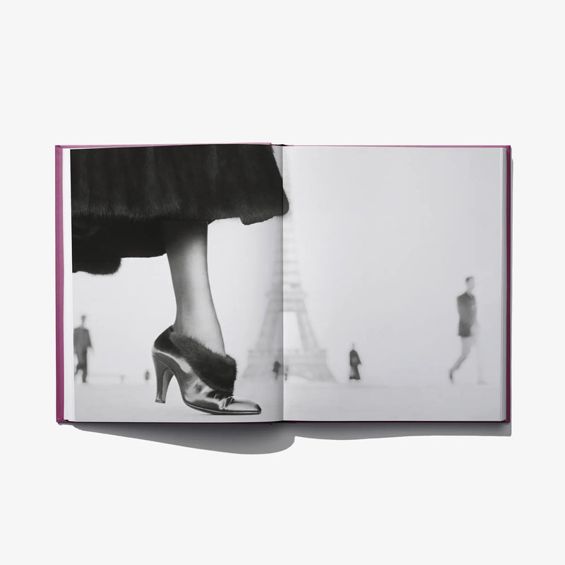 Open photo book spread with grayscale high-heel shoes and legs, with distant figures
