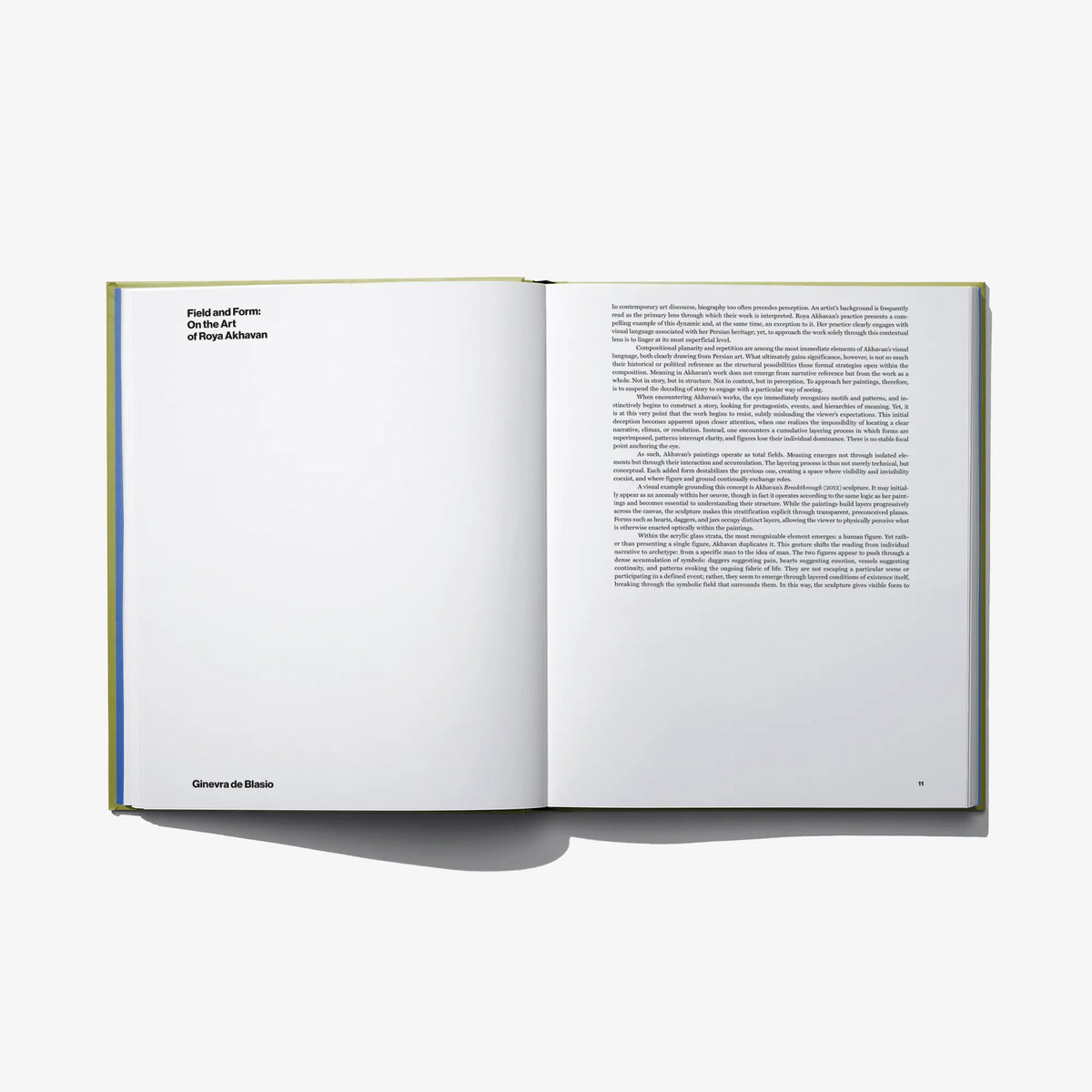 Opened art book with blank left page and text block on right page