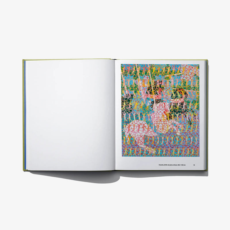 Opened art book with multicolor abstract artwork on right page