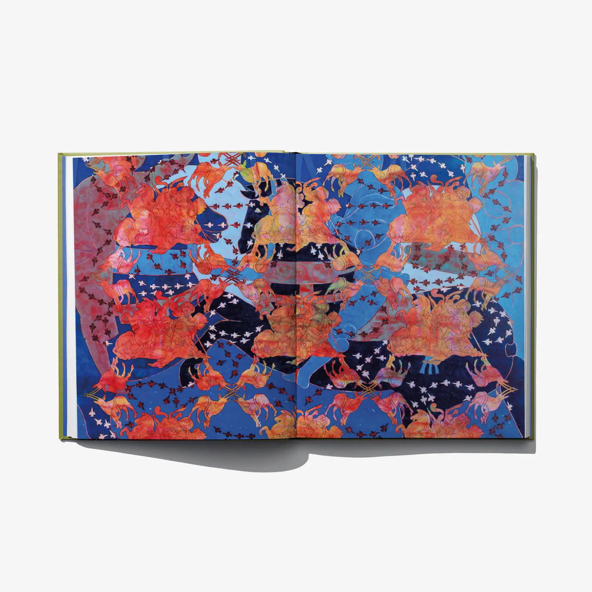 Opened art book showing blue and red abstract collage on both pages