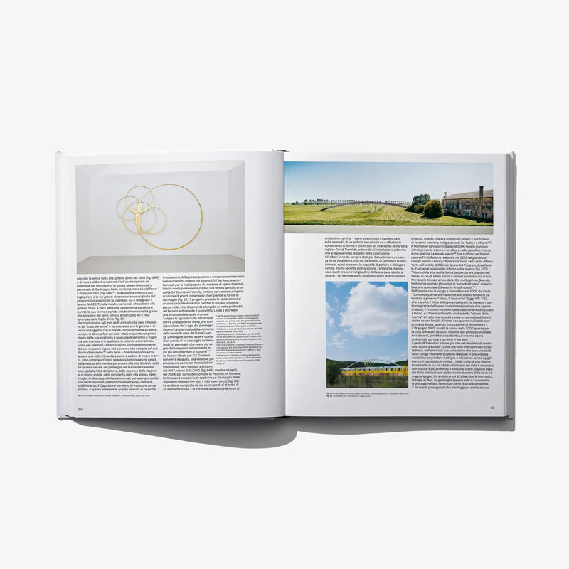 Italian edition art book open spread with wall sketch circles and landscape photo