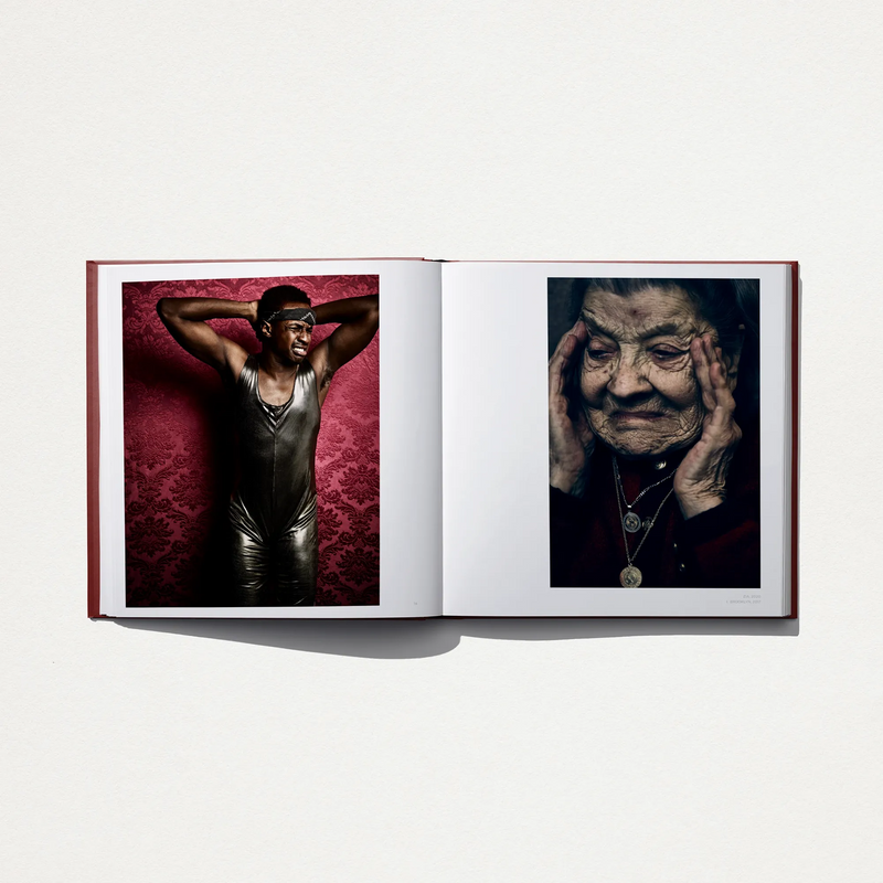 Opened hardcover book with two color portraits: a man raising arms; an elderly face close-up.