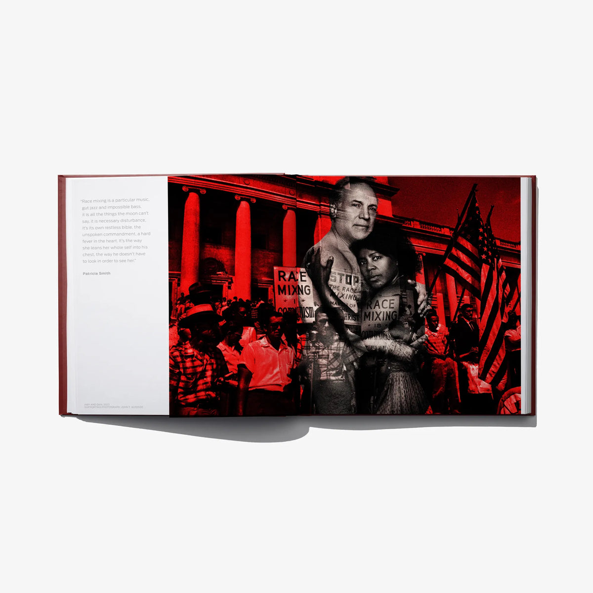Opened hardcover book featuring a red-toned stage scene with portraits of two people.