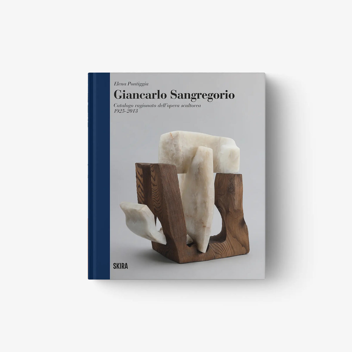 Art catalog book with blue spine and cover featuring a white sculpture artwork