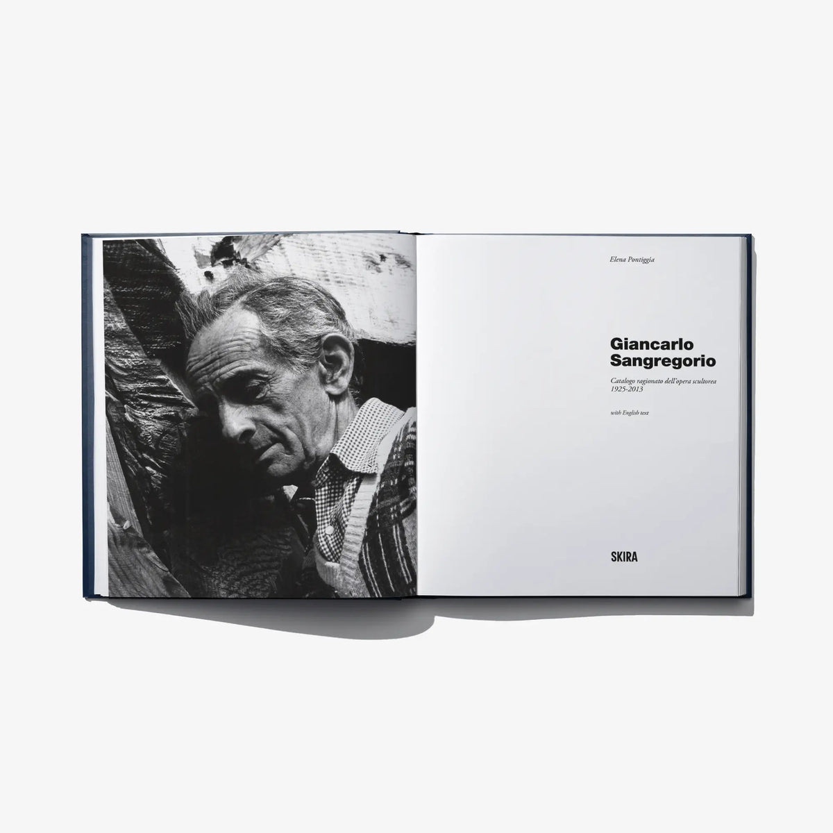 Open art catalog book with black-and-white portrait photo and text pages