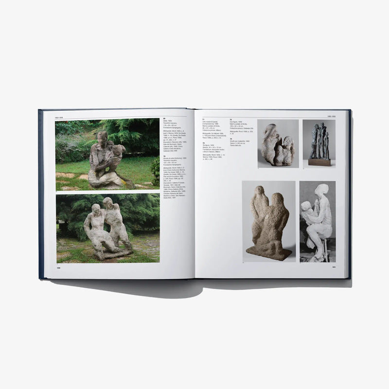 Open art catalog book with outdoor sculpture photos and side details