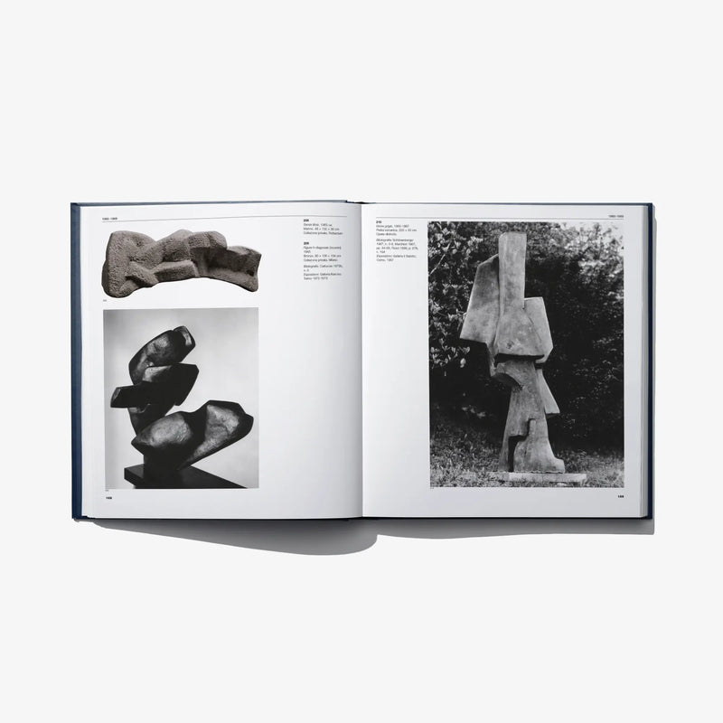 Open art catalog book with photos of sculptures on two pages