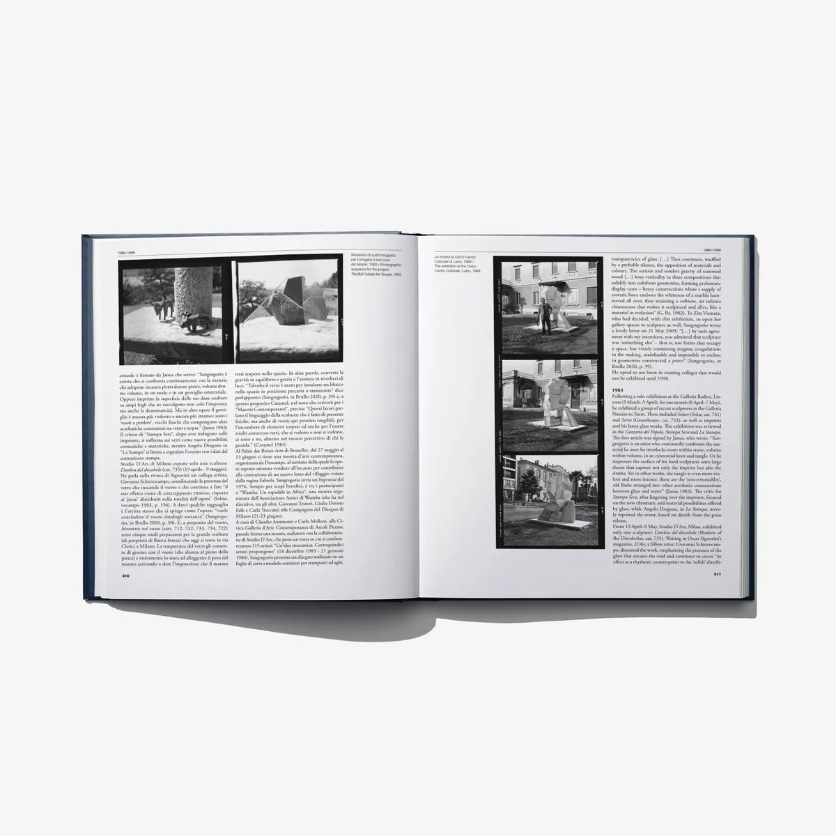 Open art catalog book with multiple black-and-white photo panels and text