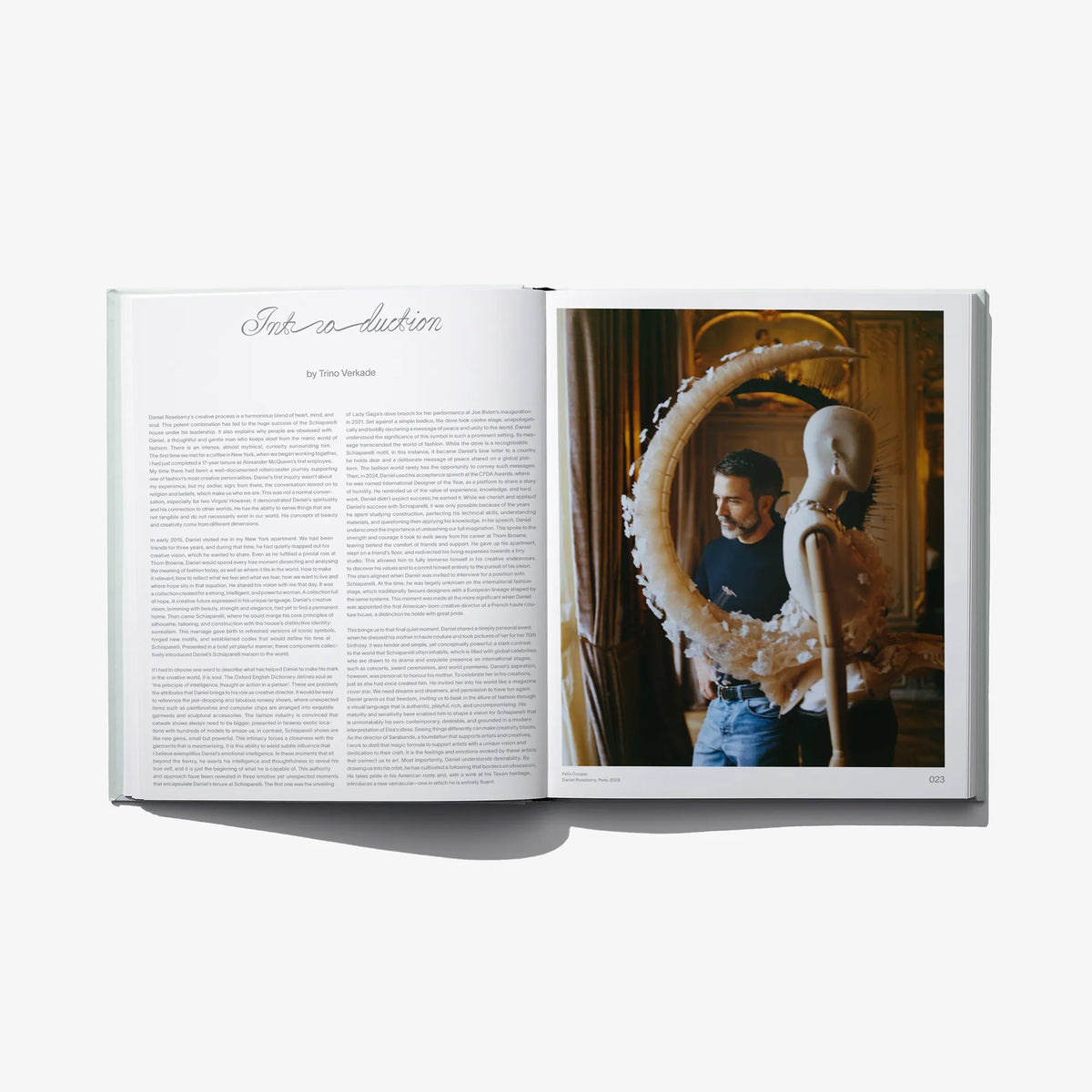 Open fashion catalog spread with text page and photo of a couple in dresswear