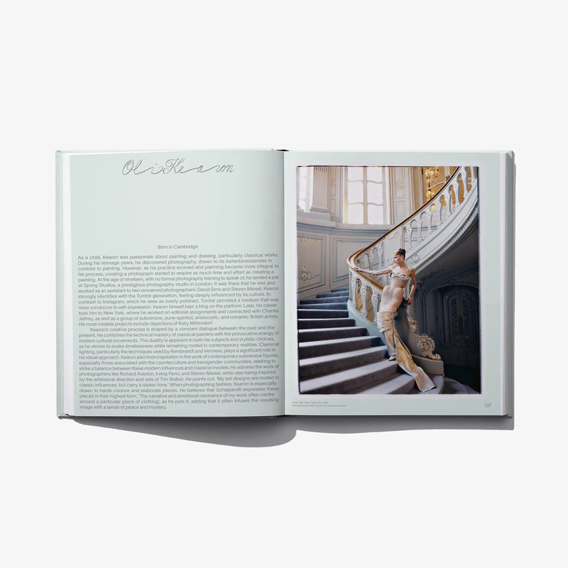 Open fashion catalog spread with text page and staircase portrait photo