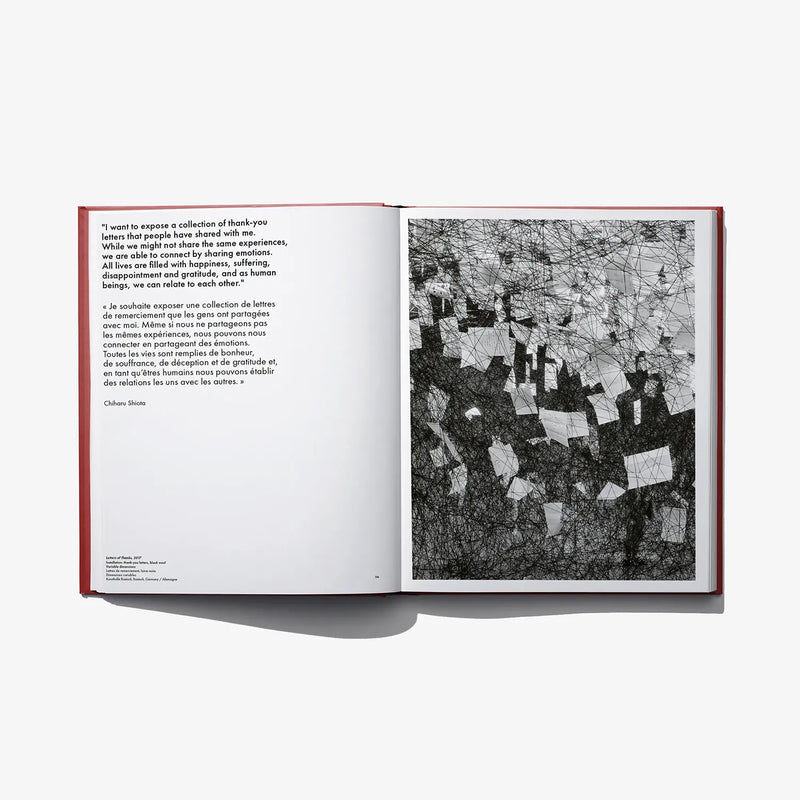 Open art book spread with paragraph text on left and black-and-white artwork panel on right