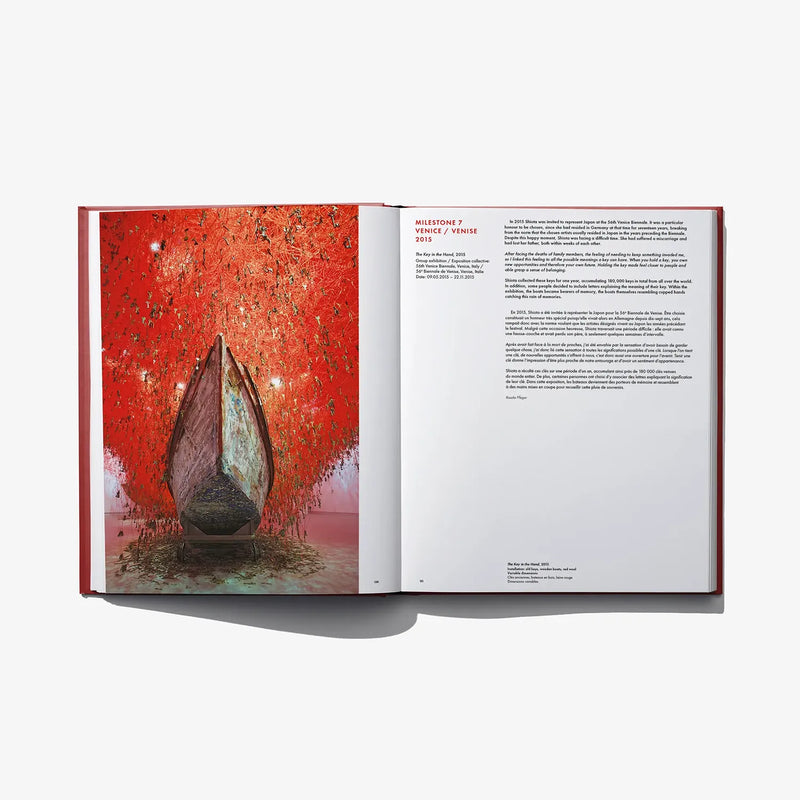 Open art book spread with red abstract artwork featuring a tall central form on left