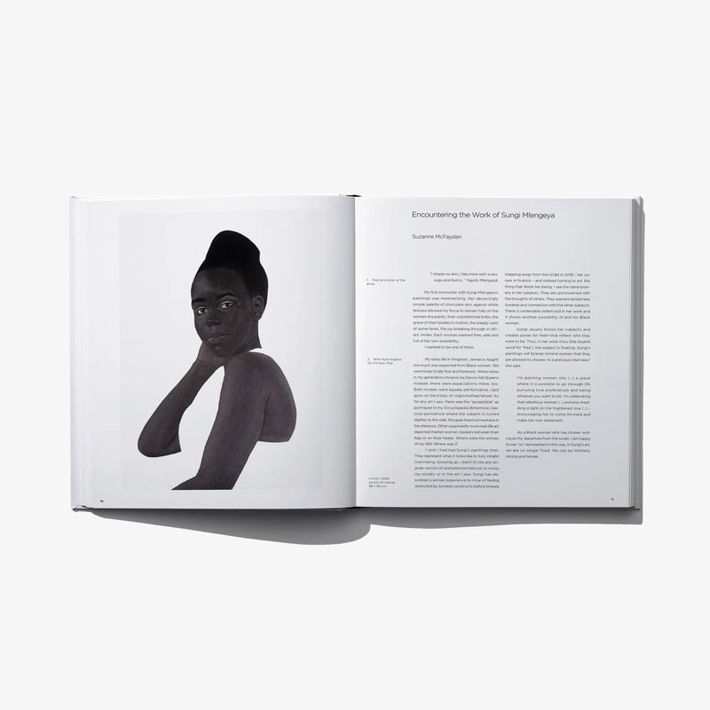 Art photo book open spread with black-and-white figure portrait and caption text