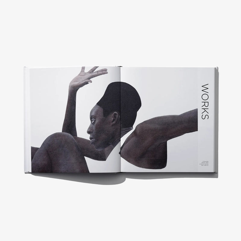 Art photo book open spread with black-and-white figure in motion, legs raised