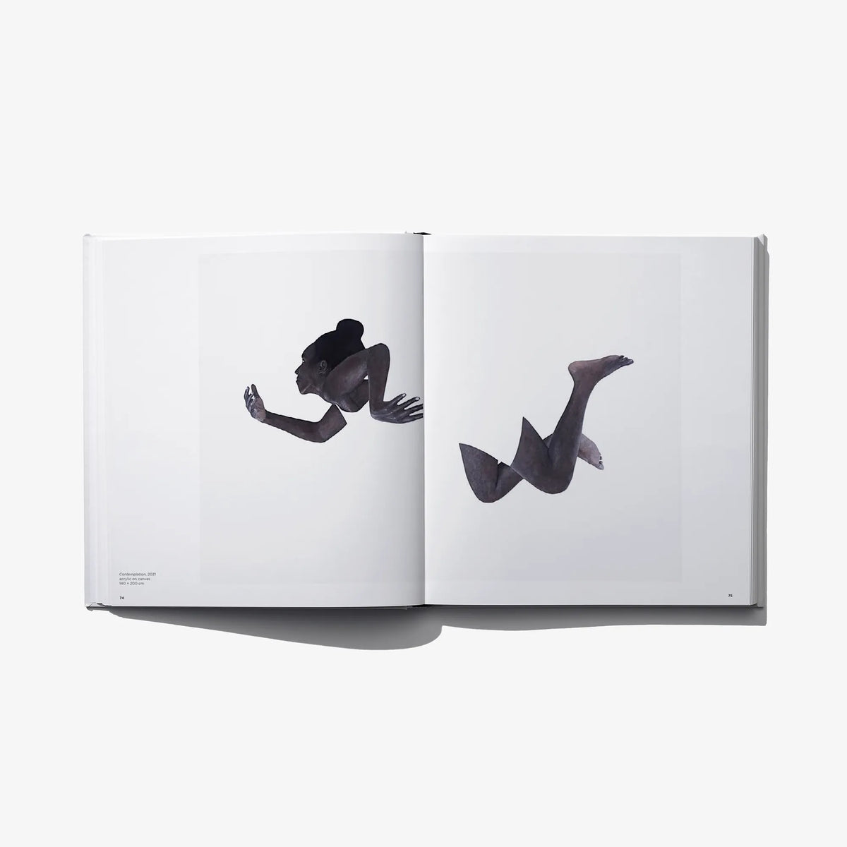 Art photo book open spread with two black-and-white seated figure photos
