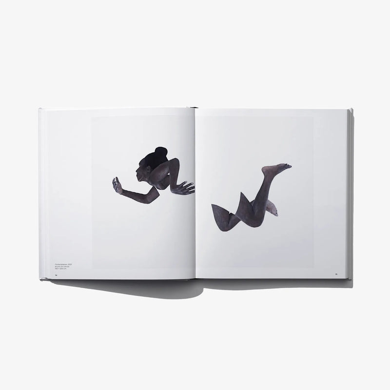 Art photo book open spread with two black-and-white seated figure photos