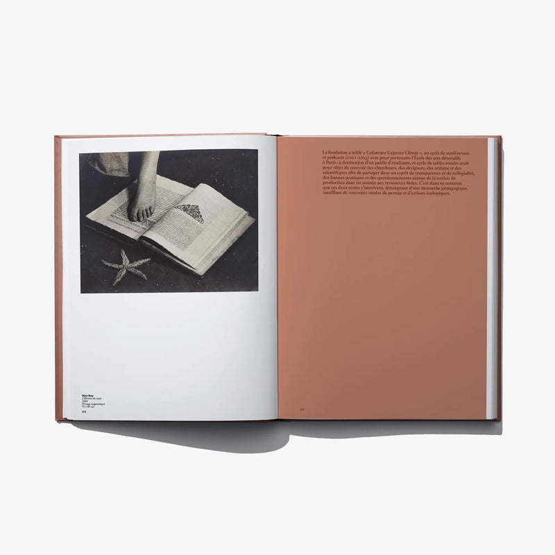 Open art book spread with a photo of writing in an open book on the left