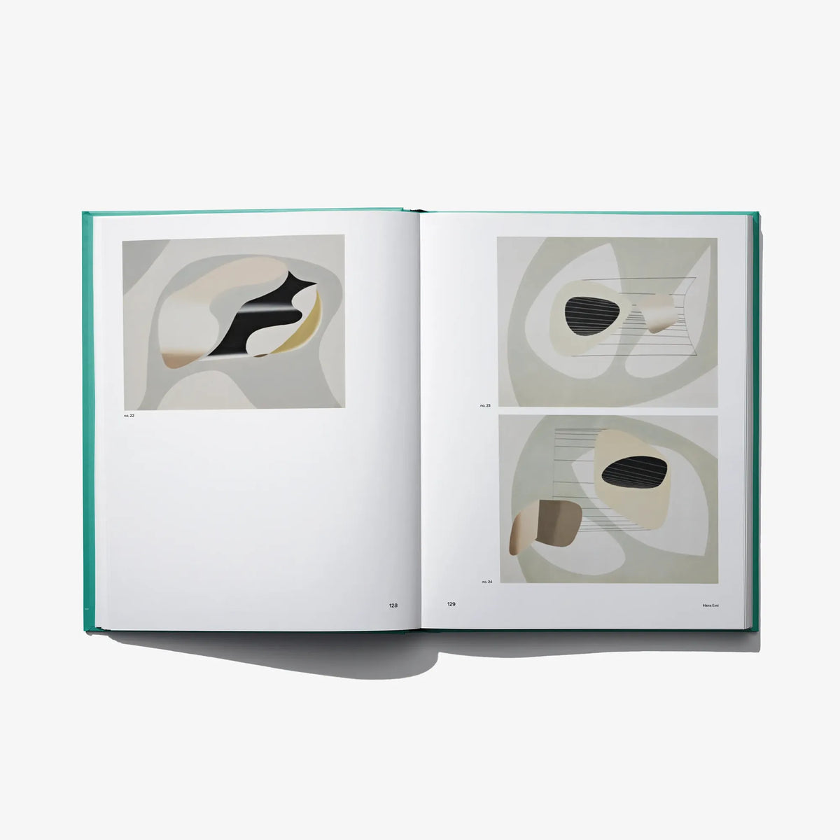 Open art book spread showing two abstract prints with captions
