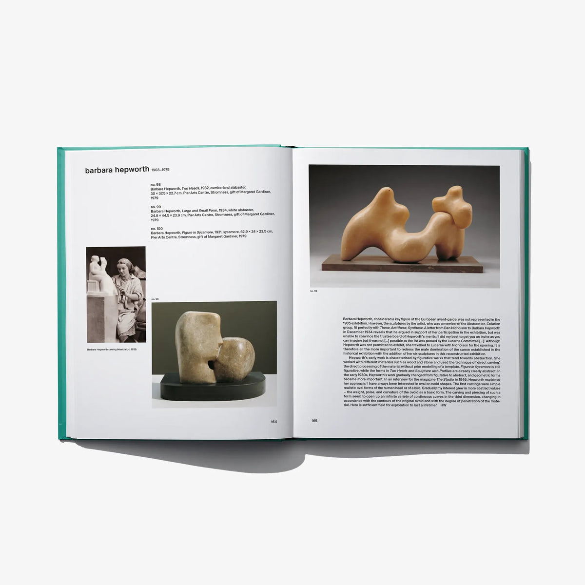 Open art book spread with bronze sculpture photo and text on facing pages