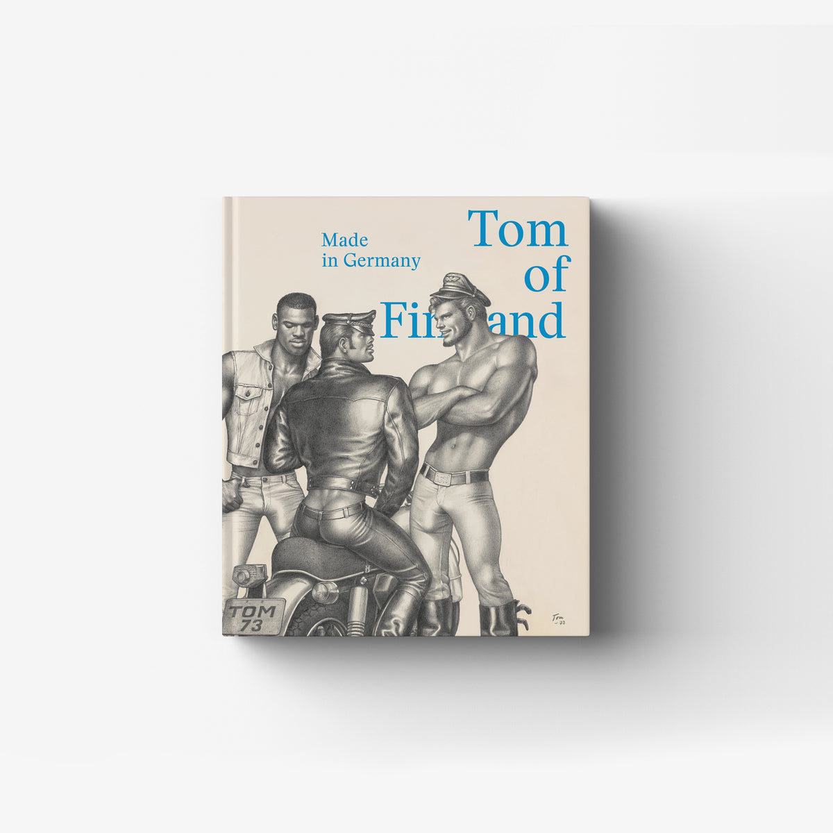 Hardback art book with blue title text and black and white figures, Skira Arte, Tom of Finland Made in Germany