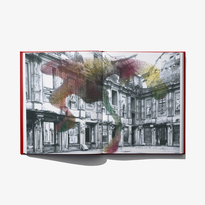 Open photo book spread with colorful abstract art over black-and-white building images
