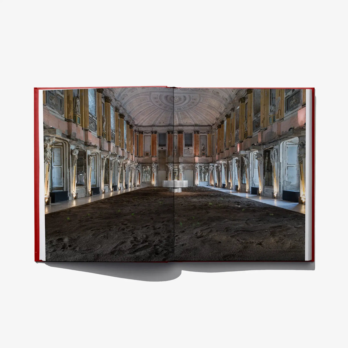 Open photo book spread showing a large interior hall with columns and arches