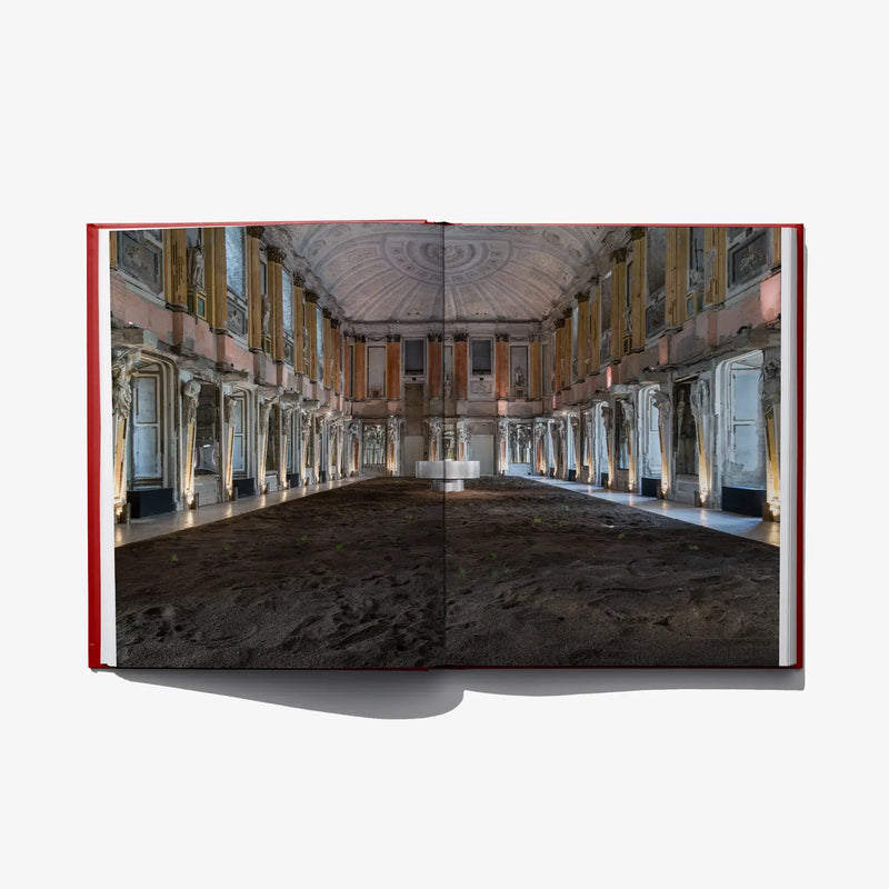 Open photo book spread showing a large interior hall with columns and arches