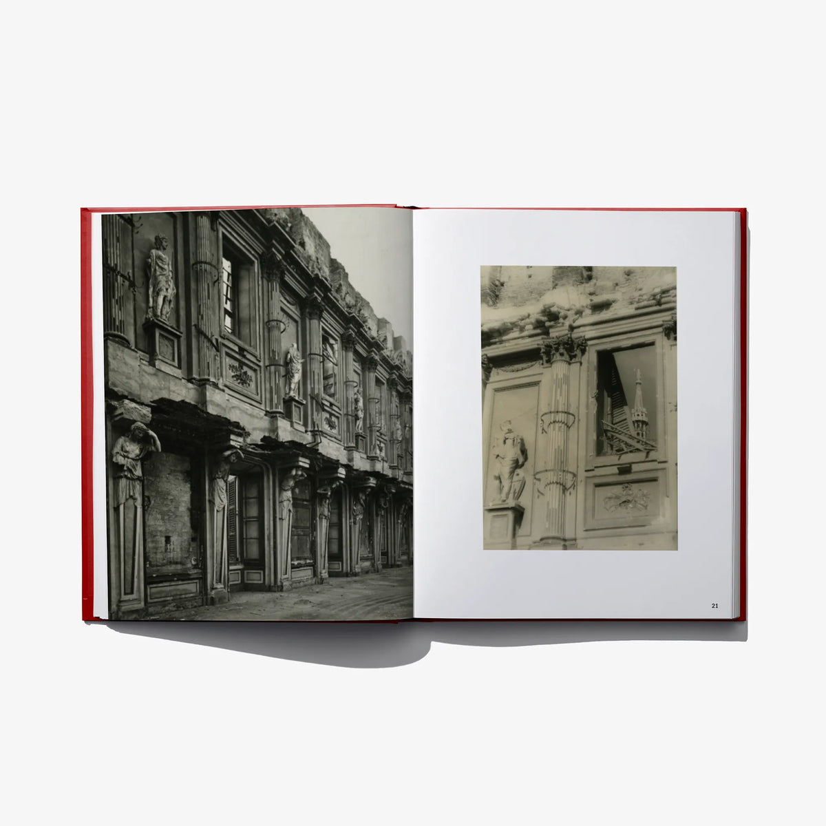 Open photo book spread with black-and-white street building photo and a small inset