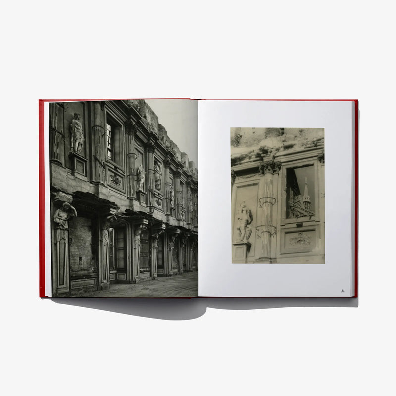 Open photo book spread with black-and-white street building photo and a small inset