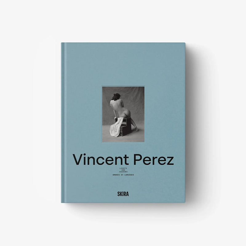 Light blue hardcover book with central photo and black title lettering