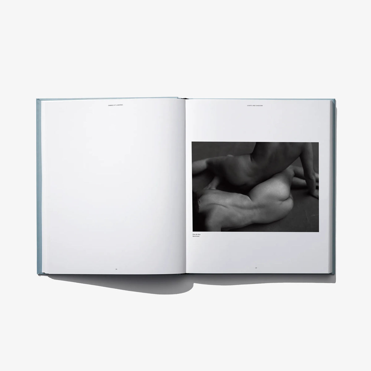 Open book spread with close-up black-and-white photo of hands and torso