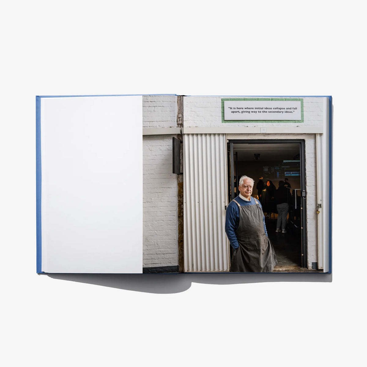 Open art book spread with a building entrance photo and a green caption box