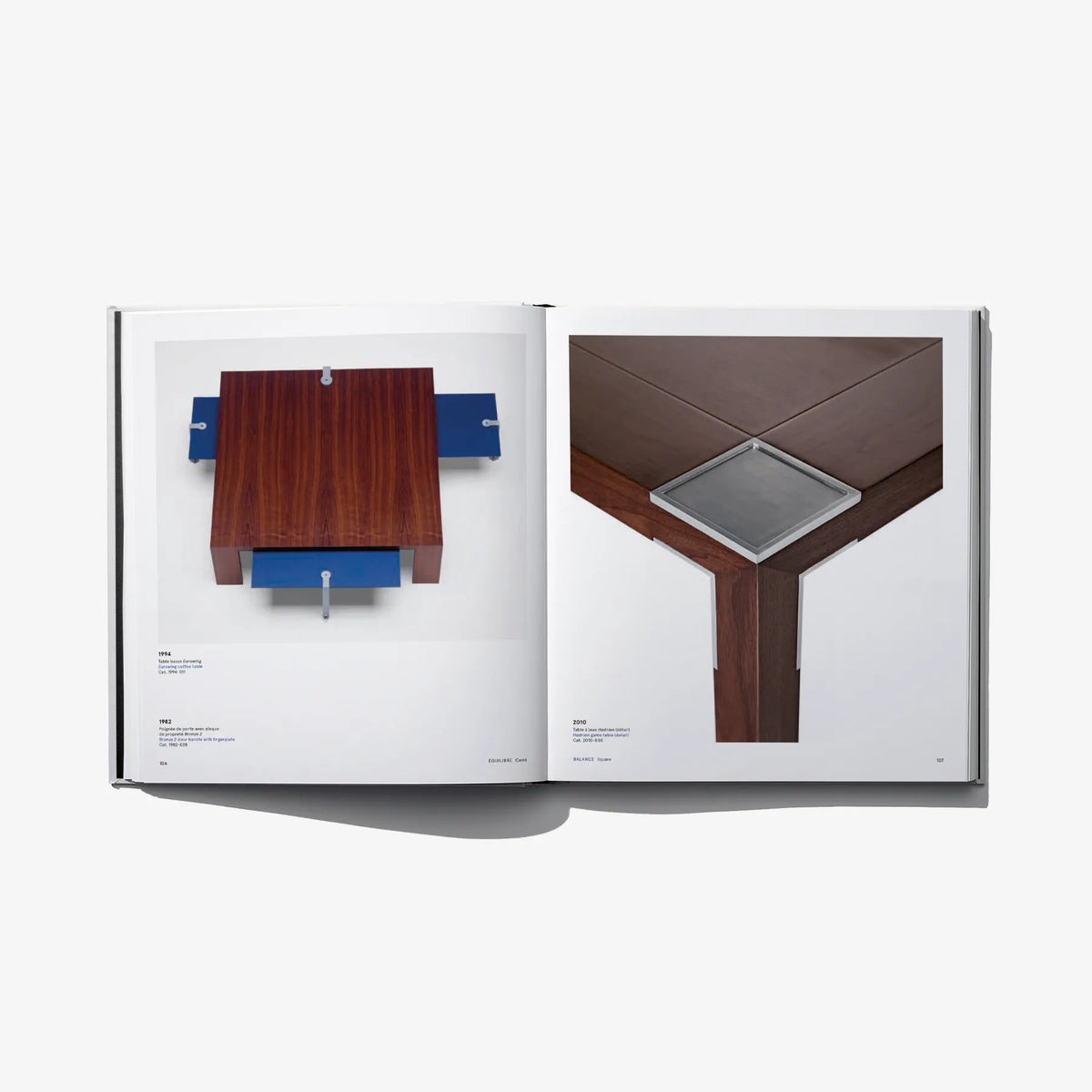 Open design book with printed text and photos of wooden tabletop and base