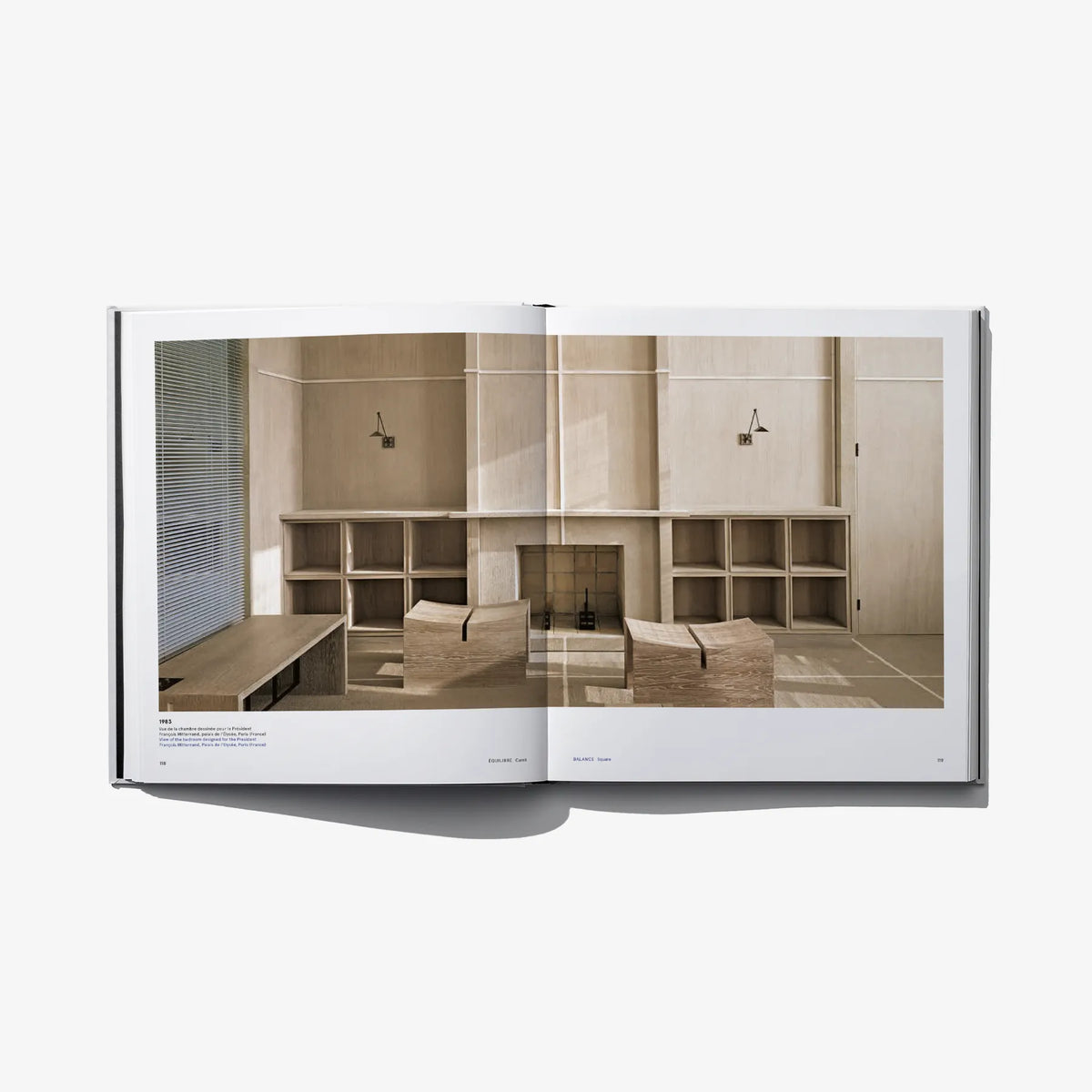 Open design book showing printed text and photo of built-in shelving interior