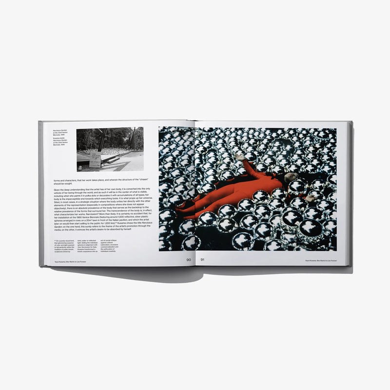 Open art book spread with black floral pattern and orange sculpture-like shape