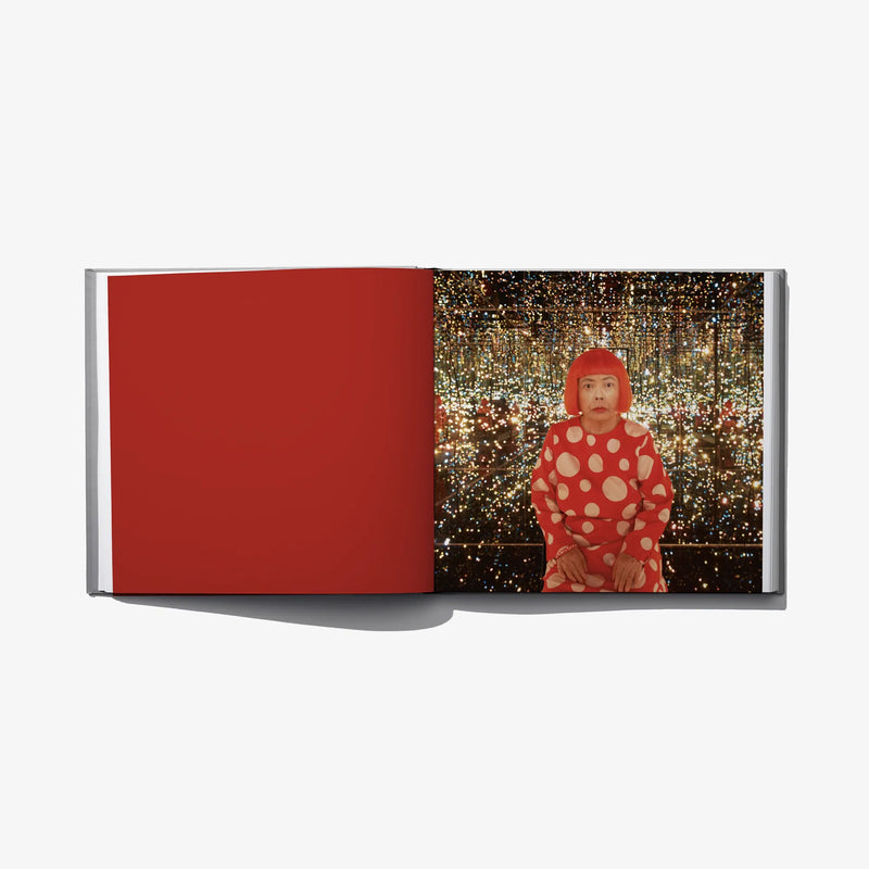 Open art book spread: red page and photo of a polka-dot figure
