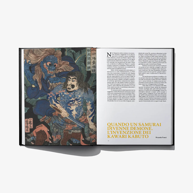 Open book spread with blue yokai figures and samurai, plus text on white page