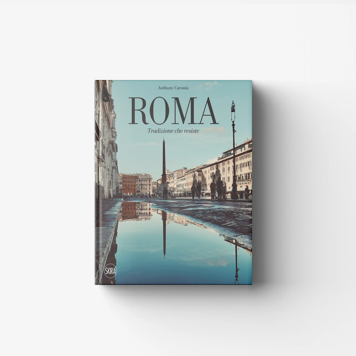 Hardback book by Skira Arte titled Roma, with illustrated pages and a pale blue cover featuring city views
